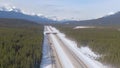 AERIAL: Flying above a overpass running over a highway in the Canadian mountains