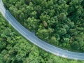 AERIAL: Flying above person riding their motorbike along an empty asphalt road. Royalty Free Stock Photo