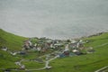 AERIAL: Flying above a remote small Scandinavian coastal town on a cloudy day.
