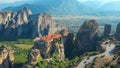 AERIAL: Flying above a scenic asphalt road leading past an old Greek monastery. Royalty Free Stock Photo