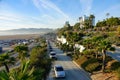 AERIAL: Flying above a scenic road leading past the famous Santa Monica Beach.