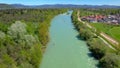 AERIAL: Flying along the emerald river coursing through the green landscape.