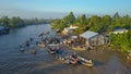 AERIAL: Flying along the muddy river and traditional floating market in Vietnam.