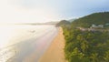 AERIAL: Flying along sandy tropical beach and tourists enjoying their holidays. Royalty Free Stock Photo