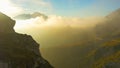 AERIAL: Flying over the idyllic grassy mountains in Slovenia at cloudy sunset.