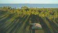 AERIAL: Flying over tranquil golf course illuminated by gentle evening sun rays. Royalty Free Stock Photo