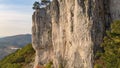 AERIAL: Flying towards a fearless rock climber ascending up a cliff in Slovenia. Royalty Free Stock Photo