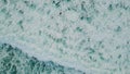 Aerial foaming sea water splashing rolling in slow motion. Surfer swimming ocean Royalty Free Stock Photo