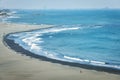 Aerial of foamy waves approaching the shoreline at a beach on Cijin Island in Taiwan