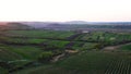 Aerial footage of an agricultural area and green rolling fields.