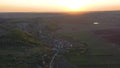 Aerial footage of an agricultural area and green rolling fields.