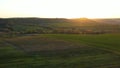 Aerial footage of an agricultural area and green rolling fields.