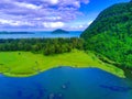 aerial footage of beautiful babah ie village with pond and savannah and pine trees, aceh jaya, Indonesia. Royalty Free Stock Photo