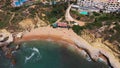 Aerial footage of the beautiful beach front of Albufeira in Portugal, showing the small private beach of Praia dos Aveiros with