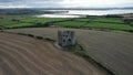 Aerial footage of Burt Castle in Burt, County Donegal, Ireland, surrounded by green lands
