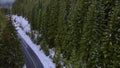 Aerial footage over a road in the mountains in winter season