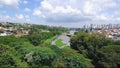 Aerial footage starting from a park with trees to the bridge of the lake. Igapo lake in Londrina PR, Brazil
