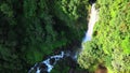 Aerial footage of waterfall flowing with contras exposure on each side