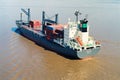 view of a loaded container cargo vessel traveling over calm ocean