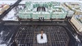 Aerial front view at the Winter Palace building, exterior with snow Palace Square and Aleksandr Column at winter season. Top view. Royalty Free Stock Photo