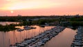 Aerial full HD video of yacht club marina during sunset hour.