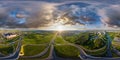 aerial full spherical seamless hdr 360 panorama over huge road junction of freeway at height of 100 meters at susnset in