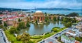 Aerial full view Palace of Fine Arts lagoon and colonnade pillars with Golden Gate Bridge