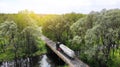 Aerial. Gasoline fuel truck driving through the bridge over the river. View above from drone Royalty Free Stock Photo