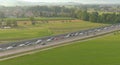 AERIAL: Golden summer sunbeams shine on vehicles stuck in a jam on the motorway