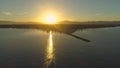 AERIAL: Golden sun rising above exotic Fiji island on early morning in summer Royalty Free Stock Photo