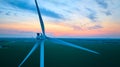 Aerial gorgeous sunset over wind farm and green farmland with close up of wind turbine Royalty Free Stock Photo