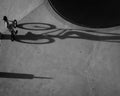 Aerial grayscale shot of TX biker at the skate park casting a long shadow Royalty Free Stock Photo