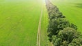 Aerial. Green landscape with a country road in the field Royalty Free Stock Photo