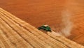 Aerial. Harvester works in a wheat field. Crop harvesting.