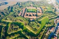 Aerial helicopter view of walls, moats, bastions, earthworks, outworks and barracks of six-star hexagon shaped renaissance fort