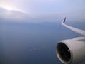 Aerial high in the sky shot with the jet and wing of a commercial jet plane that turns upwards on the right side Royalty Free Stock Photo