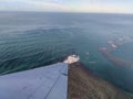 Aerial high in the sky shot of window view of plane leaving Hawaii