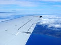 Aerial high in the sky shot of window view of plane leaving Honolulu Royalty Free Stock Photo