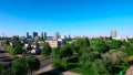 Aerial high view of Minsk, the capital of republic of Belarus. Summer cityscape with flying drone. Blue clear sky and green trees