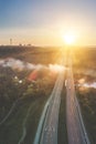 Aerial highway road at sunrise near river