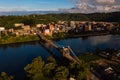 Aerial of Historic Wheeling Suspension Bridge + Downtown Buildings - Ohio River - Wheeling, West Virginia