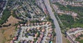 Aerial hold shot of houses and highway in suburbs of san mateo county, sf bay area california, USA