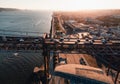 Aerial horizontal photo of streets and buildings of Lisbon on sunset. The Bridge of 25 april in Libson with harbor and Tagus river Royalty Free Stock Photo