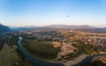 Aerial: hot air balloons in Vang Vieng backpacker travel destination in Laos, Asia. Sunset over scenic cliffs and rock pinnacles,