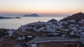 Aerial Hyper Lapse above typicall Greek Village at Sunset overlooking the Aegean sea, Cyclades, Greece