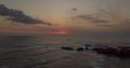 Aerial hyper lapse of beautiful sunset over sea with rocks