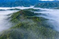 Aerial image of beautiful fresh green nature landscape scene of tropical rainforest and clouds during morning sunrise Royalty Free Stock Photo