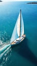 Aerial image of beautiful sailboat cruising in blue open ocean. Luxury white yacht. Generative AI Royalty Free Stock Photo