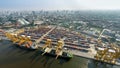 Aerial image of cargo ships at seaport with city view