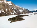 Aerial image of the Chaste islet on the frozen lake with snow covered surface